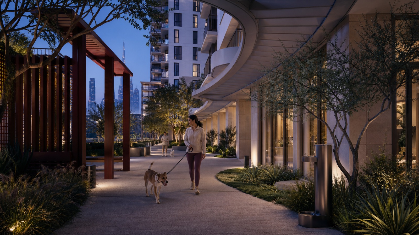 A resident walking a dog along a deeply shaded pet promenade in Dubai at dawn